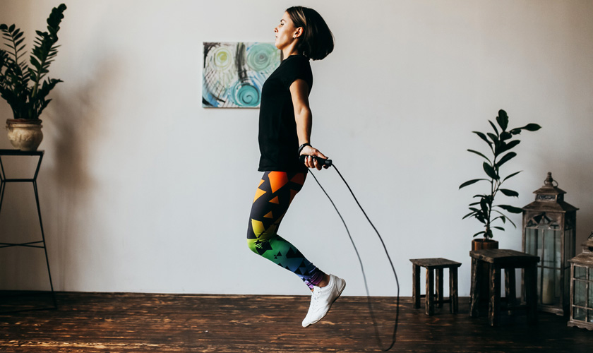 Woman exercising by skipping a rope