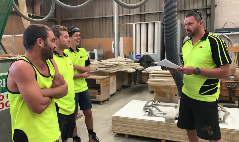 Workmen standing around in a factory