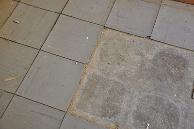 Vinyl floor tiles and bare floor showing adhesives