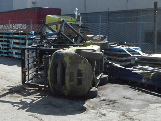 A forklift on its side at a manufacturing plant