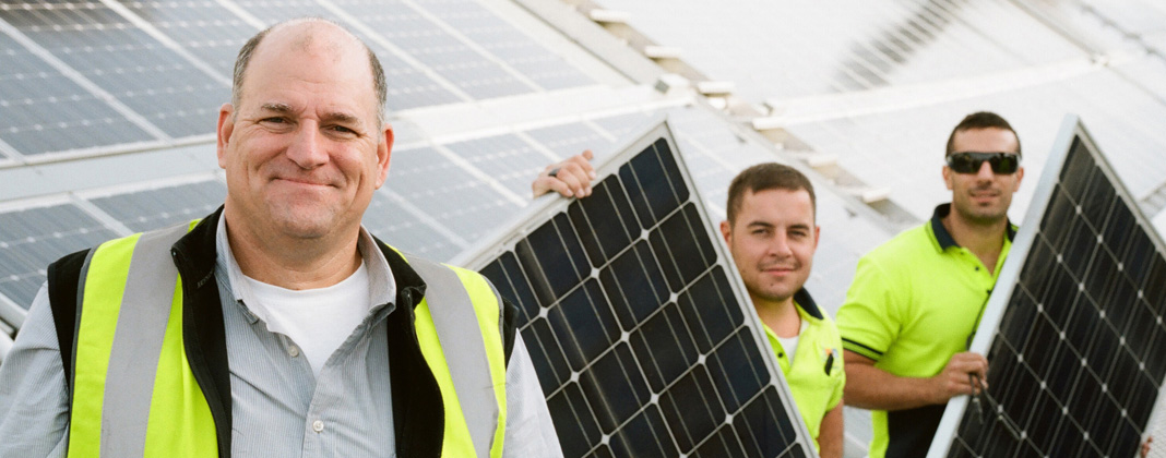 Solar supervisor and workers with solar panels