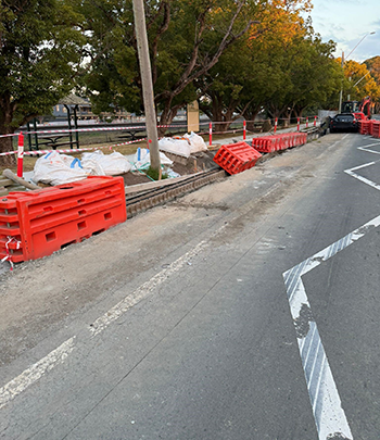 Roadworks from another angle, with displaced barriers indicating where a car struck the setup.