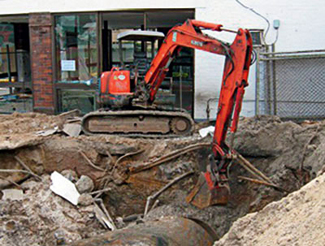 An excavator digging up an underground storage tank