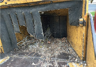 A damaged safety curtain on a woodchipper