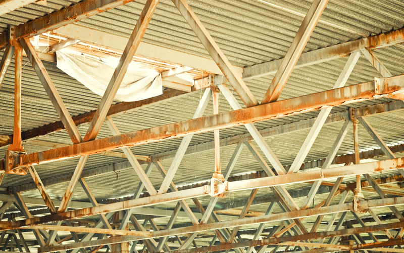Image of hole in corrugated iron warehouse roof