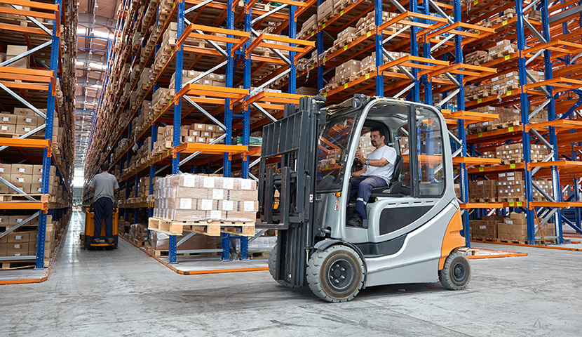 Person operating a forklift in a warehouse