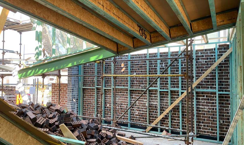 A worksite with a collapsed platform and a pile of bricks