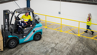 Forklift and worker in a warehouse