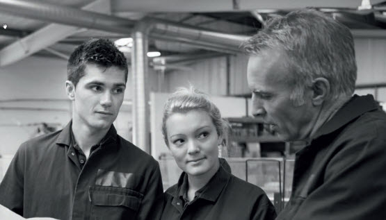 A supervisor talking with a young female and young male worker