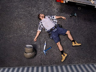 A fallen worker on a worksite, pictured from above.
