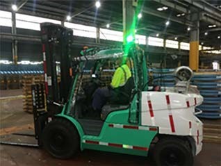 Photo of forklift with green light indicating the handbrake is on.