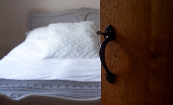 Image of a door ajar to a bedroom.