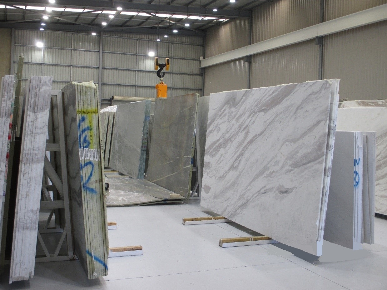 Large stone slabs on a-frame storage racks in a warehouse