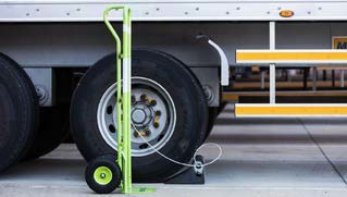 Photo of a truck with a wheel chock in place