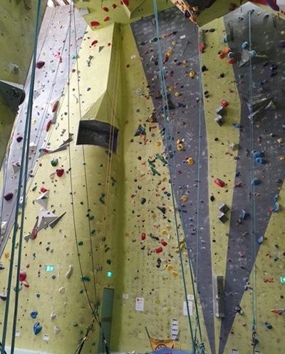 A climbing wall at a rock climbing gym