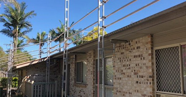Temporary roof edge protection installed on a single-level residential building.