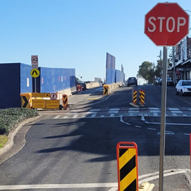 Image of bollards separating the public from a work site on a road.