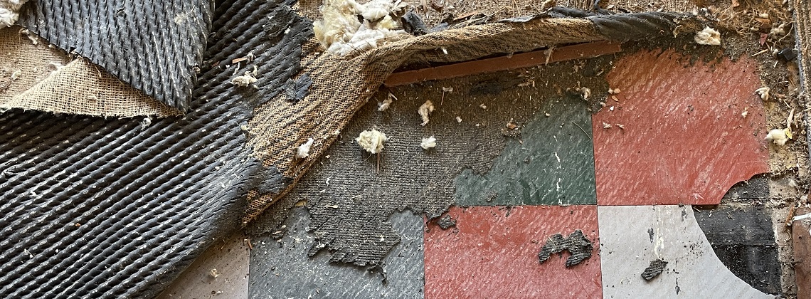 Vinyl asbestos-containing floor tiles found under carpet in an old home.