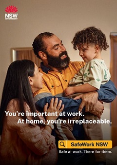 Construction worker wearing orange vest smiling next to his partner and also holding his young son